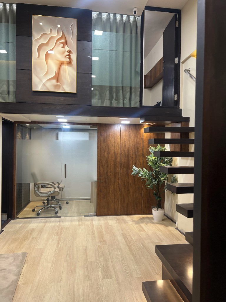 Wiora Wellness clinic atrium with glass consultation suite and floating staircase